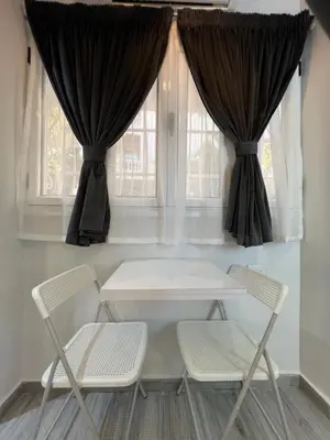 a table and two chairs in front of a window at BS Lodging 8- Next to Dream Beach in Hurghada