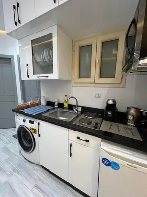 a kitchen with a sink and a washing machine at BS Lodging 8- Next to Dream Beach in Hurghada
