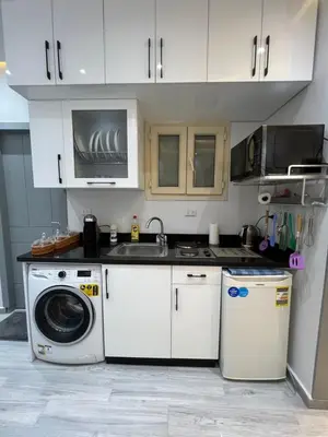 a kitchen with a washing machine and a sink at BS Lodging 8- Next to Dream Beach in Hurghada
