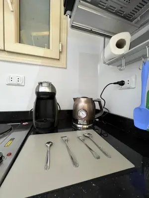 a kitchen counter with utensils on a stove top at BS Lodging 8- Next to Dream Beach in Hurghada