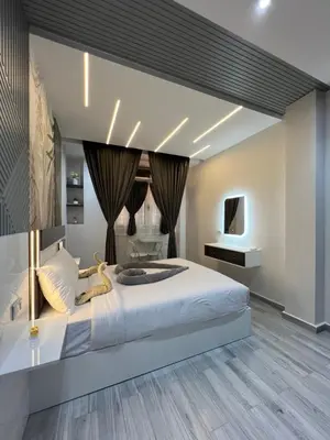 a bedroom with a large bed and a television at BS Lodging 8- Next to Dream Beach in Hurghada