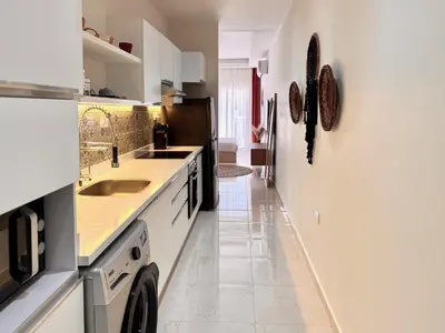 a kitchen with a sink and a washer and dryer at Comfy Studio, Pools, private Beach at peaceful Resort in Hurghada