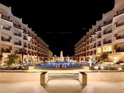 a large apartment building with a courtyard at night at Comfy Studio, Pools, private Beach at peaceful Resort in Hurghada