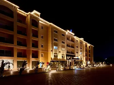 a large building is lit up at night at Comfy Studio, Pools, private Beach at peaceful Resort in Hurghada