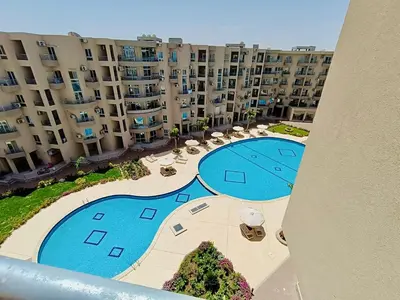 an overhead view of a large apartment complex with a swimming pool at Princess Resort Hurghada in Hurghada