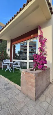 a house with a brick planter with pink flowers at Chalet private beach and pool view in Hurghada