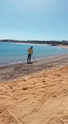 a person standing on a beach with a paddle at Chalet private beach and pool view in Hurghada