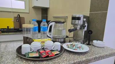 a counter with a coffee maker and some food and drinks at Chalet private beach and pool view in Hurghada