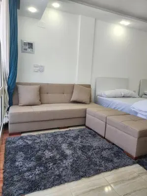 a living room with a couch and a bed at Chalet private beach and pool view in Hurghada