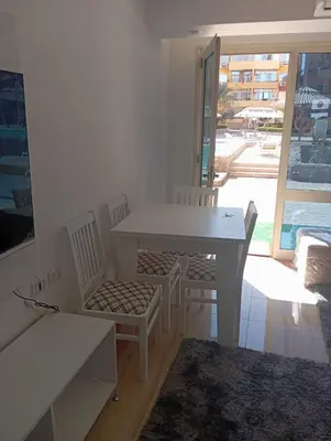 a white table and chairs in a room with a window at Chalet private beach and pool view in Hurghada