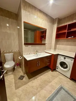 a bathroom with a sink and a washing machine at El Andalous Sea View Apartment Sahl Hasheesh in Hurghada