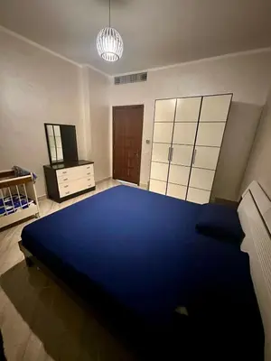 a large room with a large blue bed in it at El Andalous Sea View Apartment Sahl Hasheesh in Hurghada