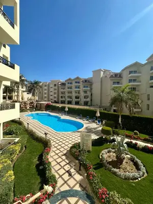 a view of a swimming pool in a resort at El Andalous Sea View Apartment Sahl Hasheesh in Hurghada