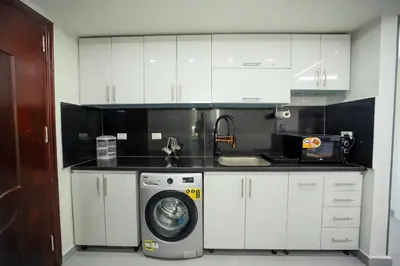 a kitchen with a washing machine and a sink at Hurghada-Scandic Resort-The Diamond Of Scandic Apartment -Sea veiw&Sandy Beach Just Downstairs in Hurghada