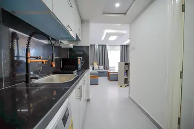 a kitchen with a sink and a living room at Hurghada-Scandic Resort-The Diamond Of Scandic Apartment -Sea veiw&Sandy Beach Just Downstairs in Hurghada