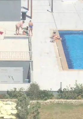 a group of people standing next to a swimming pool at Hurghada-Scandic Resort-The Diamond Of Scandic Apartment -Sea veiw&Sandy Beach Just Downstairs in Hurghada