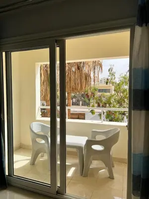 a room with a table and two chairs and a window at Sea Life Apartments-hotel in Hurghada