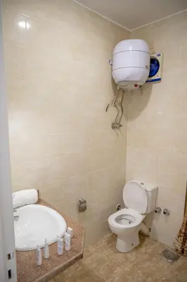 a bathroom with a toilet and a bath tub and a sink at Sea Life Apartments-hotel in Hurghada