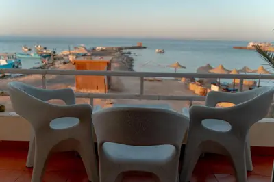 a balcony with chairs and a view of the ocean at Sea Life Apartments-hotel in Hurghada