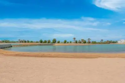 a large body of water with trees in the distance at The Lakefront Villa 4BR at Cyan ElGouna in Hurghada