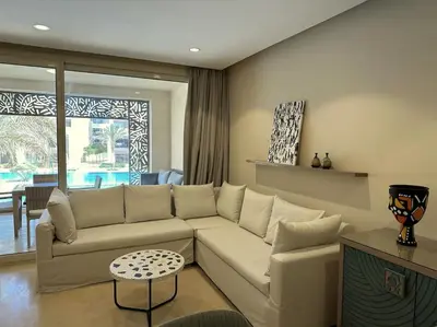 a living room with a couch and a table at Marvelous 2BR - Free Beach Access and Pool Access In Mangroovy in Hurghada