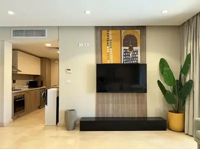 a living room with a tv on the wall at Marvelous 2BR - Free Beach Access and Pool Access In Mangroovy in Hurghada