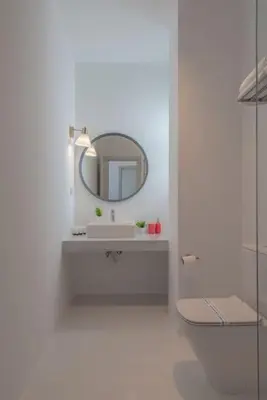 a white bathroom with a sink and a mirror at Elegant 3BR on Swan Lake Crystal Lagoon at Elgouna Families Only in Hurghada