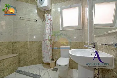 a bathroom with a toilet and a sink at The Awesome 3-Bedroom Apartment & 2 bathroom in Al-Ahyaa Hurghada in Hurghada