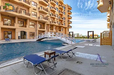 a hotel with a swimming pool and a bridge at The Awesome 3-Bedroom Apartment & 2 bathroom in Al-Ahyaa Hurghada in Hurghada