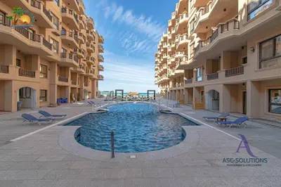 a swimming pool in the middle of a building at The Awesome 3-Bedroom Apartment & 2 bathroom in Al-Ahyaa Hurghada in Hurghada