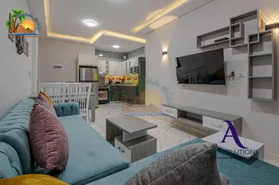 a living room with a blue couch and a tv at The Awesome 3-Bedroom Apartment & 2 bathroom in Al-Ahyaa Hurghada in Hurghada