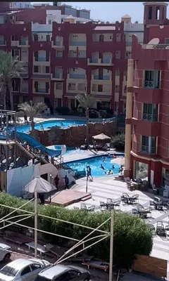 a large swimming pool in front of a building at استديو فندقى على البحر كمبوند بريستيجا اول طلعة فلفله الشيراتون in Hurghada