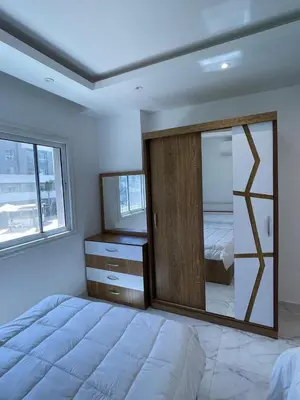 a bedroom with a large mirror and a bed at Fanadir Bay in Hurghada