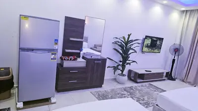 a kitchen with a refrigerator and a plant in it at شاليه ب Selena Bay Resort in Hurghada