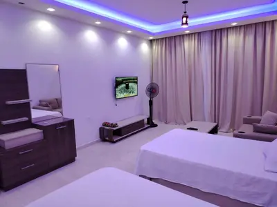 a hotel room with two beds and a couch at شاليه ب Selena Bay Resort in Hurghada