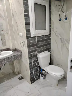 a bathroom with a toilet and a sink and a mirror at شاليه ب Selena Bay Resort in Hurghada