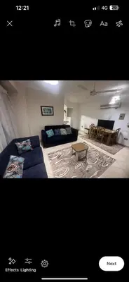 a picture of a bedroom with a bed and a table at Happy home in Hurghada