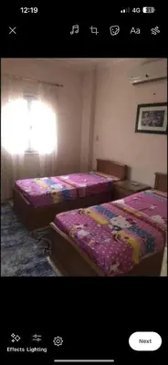two beds sitting next to each other in a room at Happy home in Hurghada