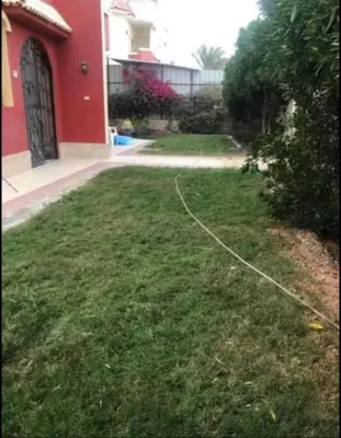 a yard with a hose in front of a house at Happy home in Hurghada