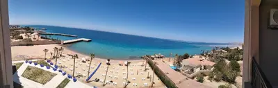 a view of a beach with chairs and umbrellas at جوليانا بيتش ريزورت in Hurghada
