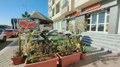 a restaurant with potted plants outside of a building at جوليانا بيتش ريزورت in Hurghada