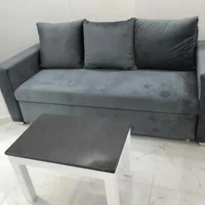a couch with a coffee table in a living room at جوليانا بيتش ريزورت in Hurghada