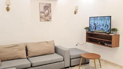 a living room with a couch and a flat screen tv at Selena Bay Resort Chalet in Hurghada
