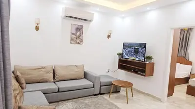 a living room with a couch and a tv at Selena Bay Resort Chalet in Hurghada