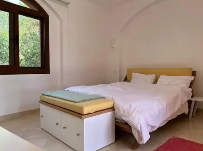 a bedroom with a large bed with a window at Cozy Townhouse in West Golf - El Gouna in Hurghada