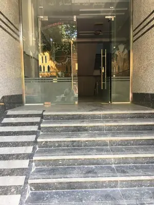 a set of stairs in front of a store at Abbady tower in Jazīrat al ‘Awwāmīyah