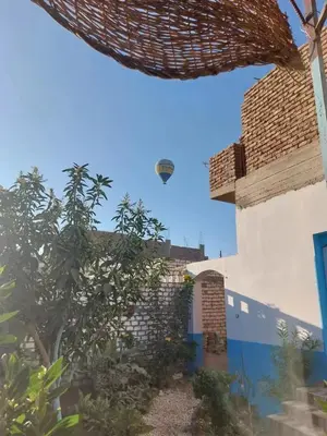 a view of a house from the garden at Osama House Luxor in Al Qurnah
