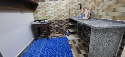 a kitchen with a sink and a blue floor at Osama House Luxor in Al Qurnah