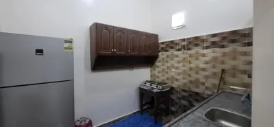 a kitchen with a refrigerator and a sink at Osama House Luxor in Al Qurnah