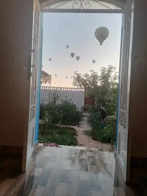 an open door with a view of a garden at Osama House Luxor in Al Qurnah